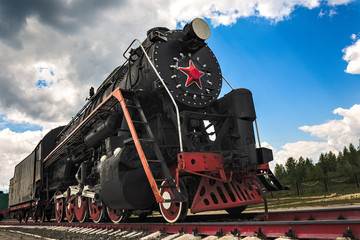 vintage steam train hurtling at speed along the rails close-up, retro vehicle, steam engine