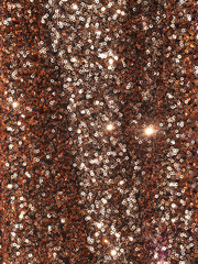 Rose gold sparkle glitter background. Crumpled fabric with glittering sequins texture
