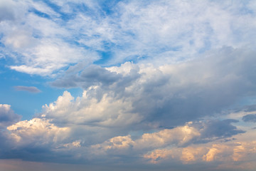 the sun shining through the clouds against the blue sky, light clouds in the sky