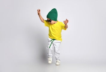Happy boy is jumping at studio.