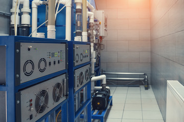 Ozone generator for ozonation of pure drinking water in water production factory, close up.