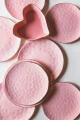 Beautiful plates on a white background with dried plant. Beautiful layout
