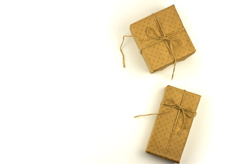 Two boxes in eco paper on a white background. View from above. Parcels or gifts tied with twine. eco packaging for christmas. Flat lay, copy space.