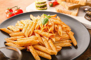 Tasty pasta with tomato sauce on plate, closeup