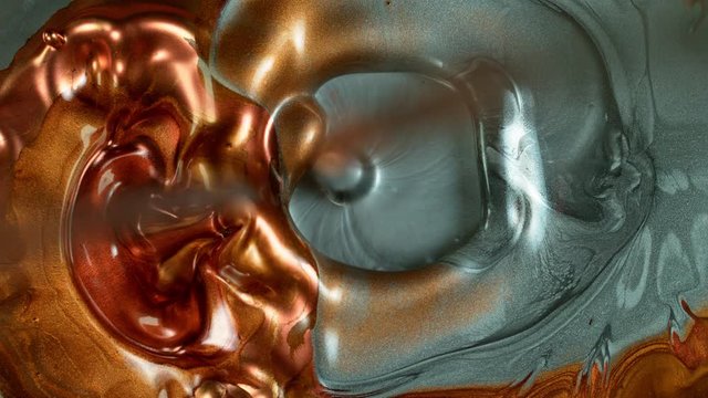 Super Slow Motion Shot of Cooper and Silver Metallic Background at 1000fps.