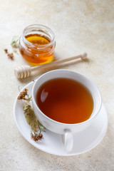 Cup of of tea with honey and teapot