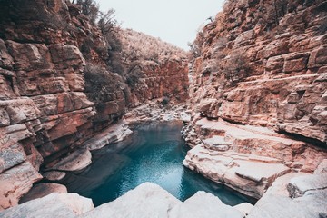 Small lake inside a canyon near the rock formations in the Paradise Valley in Morocco, Africa - obrazy, fototapety, plakaty