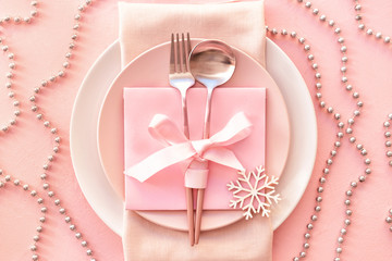 Beautiful table setting for Christmas dinner on color background