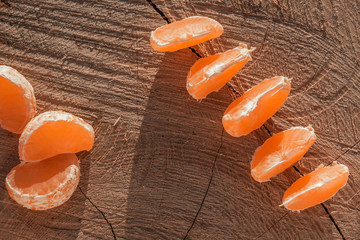 tangerine slices on a wooden background