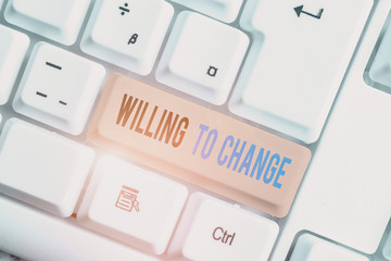 Text sign showing Willing To Change. Business photo text Desire to grow Eager to accept and adopt new ideas White pc keyboard with empty note paper above white background key copy space