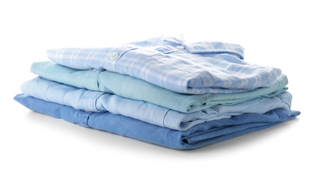 Stack of clean clothes on white background