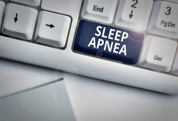 Conceptual hand writing showing Sleep Apnea. Concept meaning disorder which demonstrating repeatedly stop breathing when asleep White pc keyboard with note paper above the white background