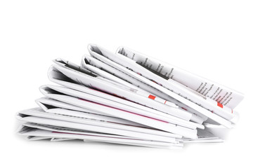 Many newspapers on table against white background