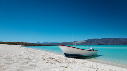 Motor boat at the paradise beach with white sand, turquoise sea and blue sky, Playa Isla Coronado, Mexico