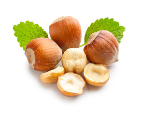 Fresh hazelnuts with green leaves, whole and cracked nuts for healthy snacking and baking ingredients, fresh hazelnuts with vibrant green leaves are arranged on a clean white background © Pixel-Shot