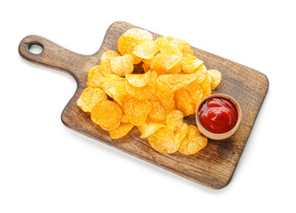 Board with tasty potato chips and sauce on white background