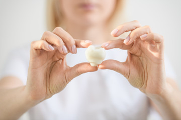 dentist holding a mock tooth