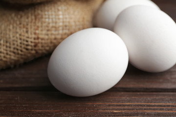 Fresh raw eggs on table, closeup
