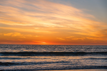 Beautiful sunset over the ocean with clouds