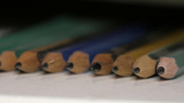 Several pencils aligned macro 4k