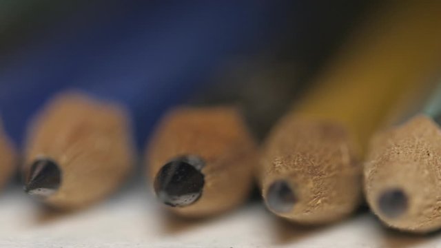 Several pencils aligned macro 4k
