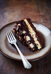 Piece of chocolate cake on rustic background. 