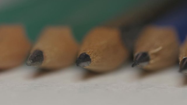 Several pencils aligned macro 4k