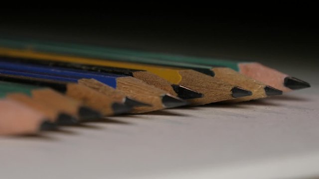 Several pencils aligned macro 4k
