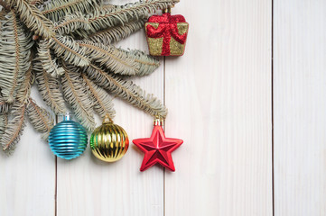 Christmas white wooden pattern with Christmas tree branches and toys