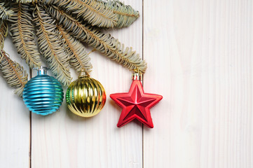 Christmas white wooden pattern with Christmas tree branches and toys