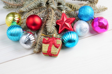 Christmas white wooden pattern with Christmas tree branches and toys
