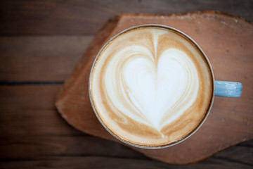 Cappuccino serving on wooden background