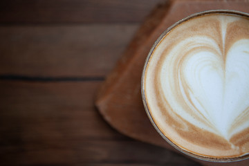 Cappuccino serving on wooden background