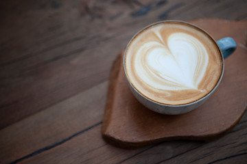 Cappuccino serving on wooden background
