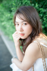Naklejka premium Beautiful wellness asian women walking in city park with white dress