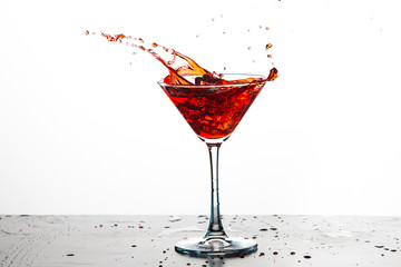 Splash Photography. Colorful Liquid Droplets With Ice Cubes Falling to Goblet. Against White Background.