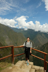 Fototapeta na wymiar Brunette overlooking Andes Mountains at Machu Picchu