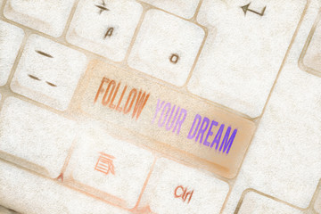 Text sign showing Follow Your Dream. Business photo text Keep track on your goals Live the life you want to be White pc keyboard with empty note paper above white background key copy space