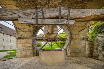 Large man powered wheel at the fountain within the Citadel of Besancon, fortifications of Vauban, UNESCO World Heritage Site, France.