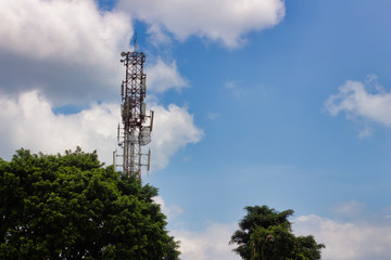 Several radio towers with blue sky in background