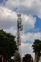 Several radio towers with blue sky in background