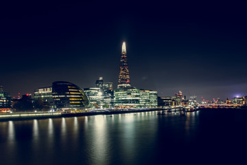 Fototapeta na wymiar View of Illuminated Buildings at Night With the Shard in the Middle, in the City of London, UK