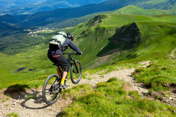 A man is riding enduro bicycle.