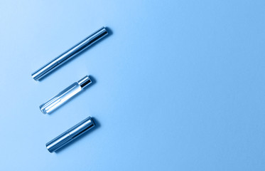 Flat lay composition with decorative makeup products and perfume in trendy blue color. Color of the year 2020 concept. Makeup and beaty concept.