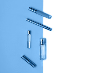 Flat lay composition with decorative makeup products and parfume on trendy blue and isolated white background. Makeup and beaty concept. Color of the year 2020 concept. Copy space.
