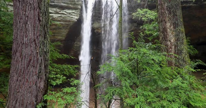 Whitewater plunges down a tall waterfall in the woods in this looping video footage shot at Ash Cave in the Hocking Hills of Ohio