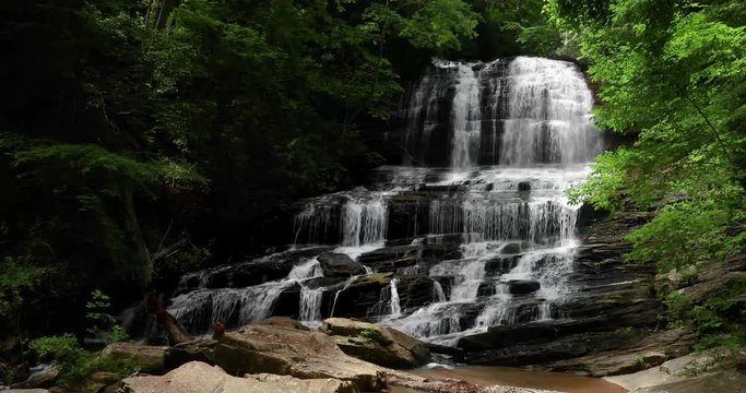 Pearson Fall, a beautiful wide cascading waterfall in the mountain woods of North Carolina, splashes over rocks in this perfectly seamless video loop