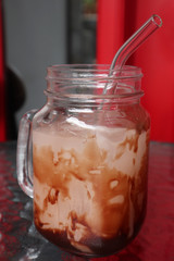 Eco-friendly a glass of ice chocolate milk with glass straw