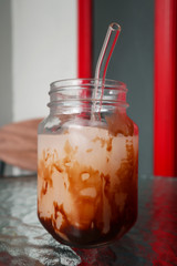 Eco-friendly a glass of ice chocolate milk with glass straw