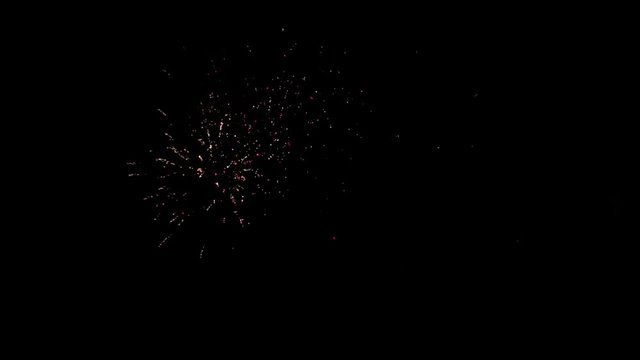 Explosion of bright colorful part of fireworks on black background to create a set salute on video for holiday new year, birthday, wedding or other celebration.